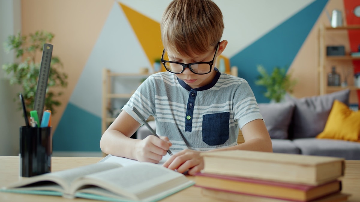 自宅の机で集中して学習する子ども